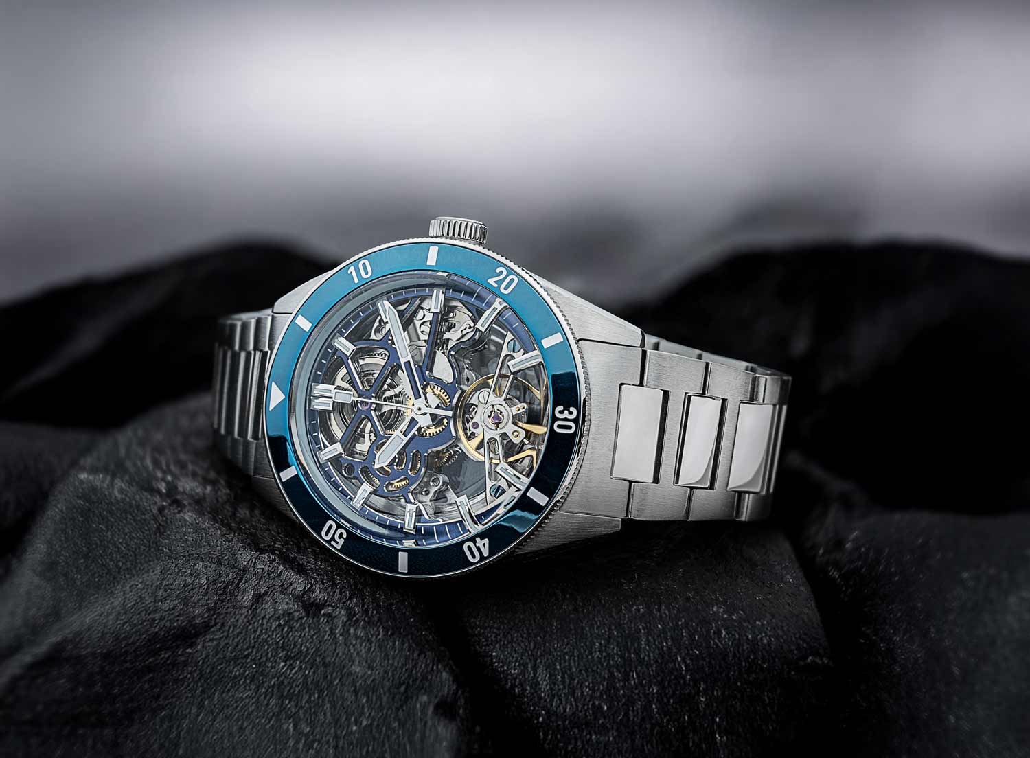 Qorum Equinox Men’s Automatic Skeleton Watch – Steel Finish Dial, Blue Bezel, Stainless Steel Strap